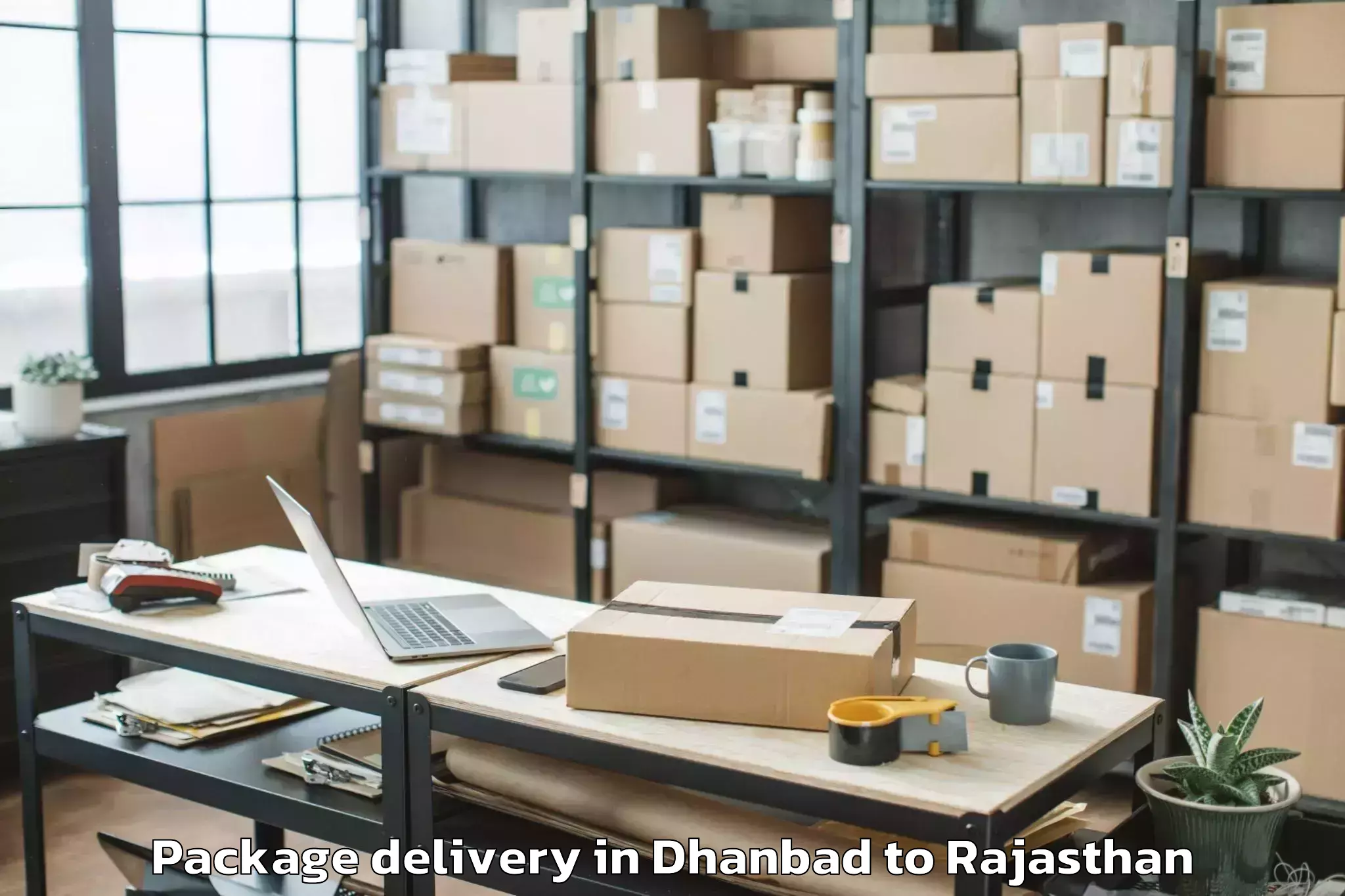 Top Dhanbad to Kherwara Package Delivery Available